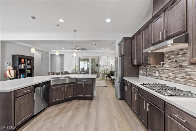 251 Castellari Dr, Las Vegas, NV 89138 - kitchen featuring appliances with stainless steel finishes, under cabinet range hood, light countertops, light wood-type flooring, and recessed lighting