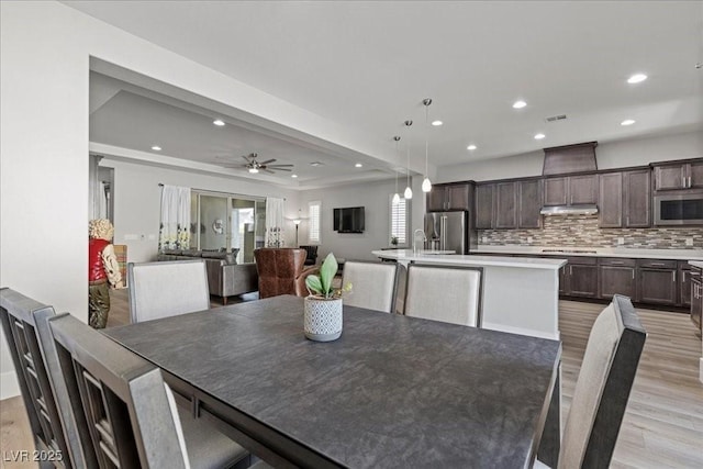 251 Castellari Dr, Las Vegas, NV 89138 - dining room with light wood finished floors, recessed lighting, a tray ceiling, and ceiling fan
