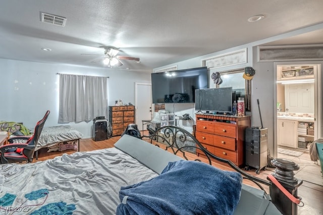 2450 Tournament St, Las Vegas, NV 89142 - bedroom with a ceiling fan, ensuite bath, and wood finished floors