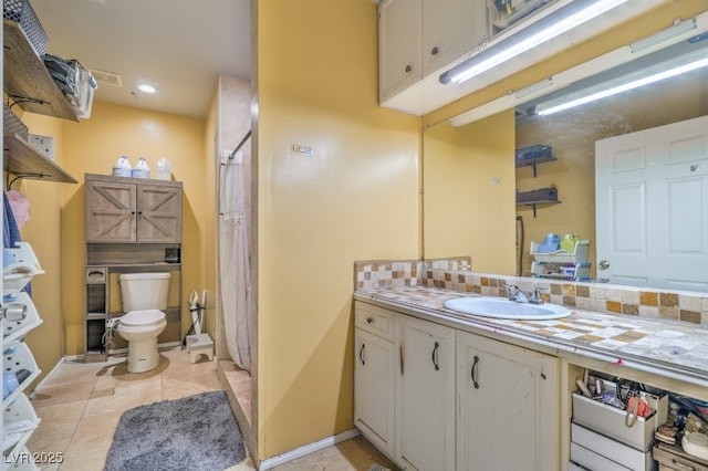 2450 Tournament St, Las Vegas, NV 89142 - full bath featuring vanity, a shower with curtain, decorative backsplash, and tile patterned floors