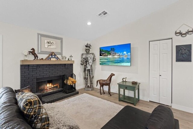 7675 Butterscotch Ct, Las Vegas, NV 89131 - living area featuring a brick fireplace, wood finished floors, and recessed lighting