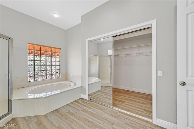 10700 Button Willow Dr, Las Vegas, NV 89134 - full bath featuring a bath, a shower stall, wood finished floors, and a spacious closet