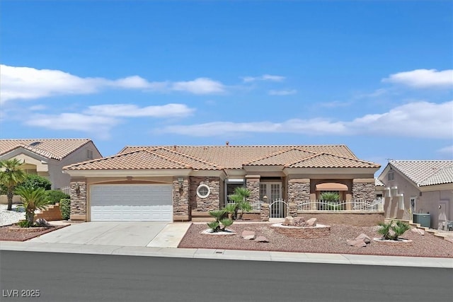 10700 Button Willow Dr, Las Vegas, NV 89134 - mediterranean / spanish-style home featuring a tile roof, stone siding, an attached garage, and driveway