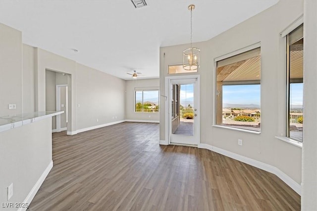 10700 Button Willow Dr, Las Vegas, NV 89134 - unfurnished dining area featuring wood finished floors, a ceiling fan, and a chandelier