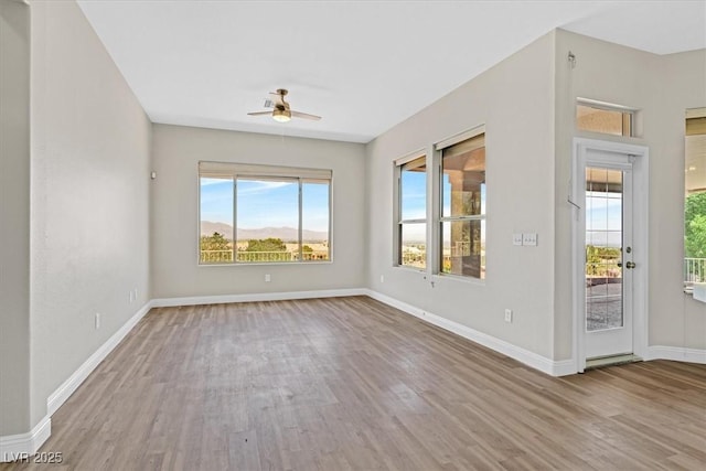 10700 Button Willow Dr, Las Vegas, NV 89134 - empty room featuring wood finished floors, a ceiling fan, and plenty of natural light