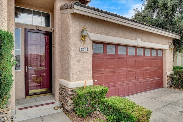 3200 Ridgecliff St, Las Vegas, NV 89129 - entrance to property with stucco siding, stone siding, driveway, a tiled roof, and an attached garage