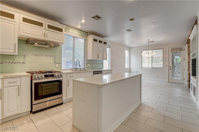 3200 Ridgecliff St, Las Vegas, NV 89129 - kitchen with stainless steel appliances, decorative backsplash, a chandelier, glass insert cabinets, and light tile patterned flooring