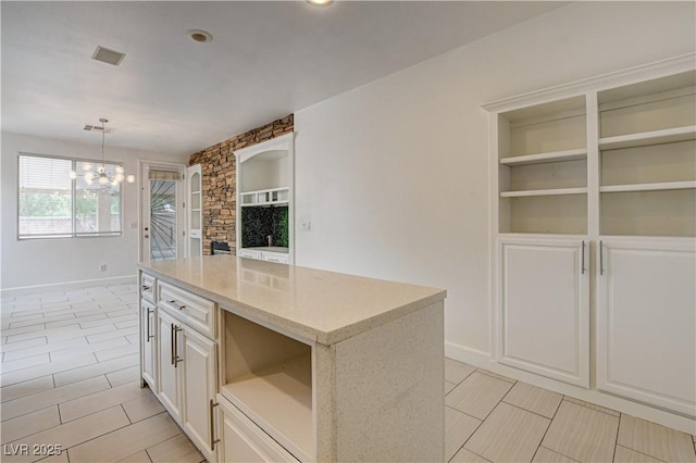 3200 Ridgecliff St, Las Vegas, NV 89129 - kitchen with open shelves, a chandelier, decorative light fixtures, light stone counters, and recessed lighting