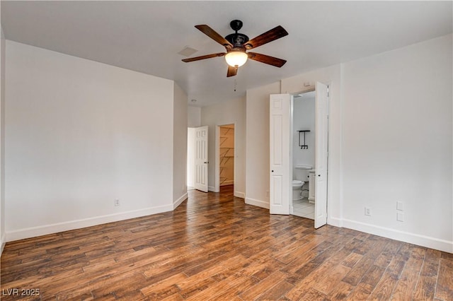 3200 Ridgecliff St, Las Vegas, NV 89129 - unfurnished bedroom with wood finished floors, connected bathroom, ceiling fan, and a walk in closet