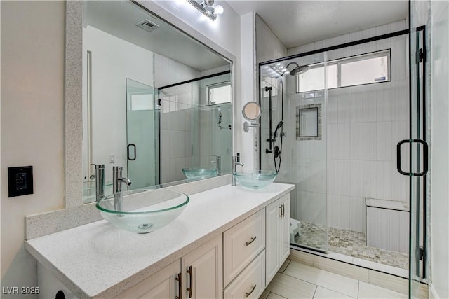 3200 Ridgecliff St, Las Vegas, NV 89129 - full bathroom featuring double vanity, a shower stall, and tile patterned flooring