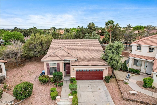 3200 Ridgecliff St, Las Vegas, NV 89129 - mediterranean / spanish home featuring a tiled roof, concrete driveway, stucco siding, and an attached garage