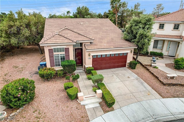 3200 Ridgecliff St, Las Vegas, NV 89129 - mediterranean / spanish house with a tiled roof, an attached garage, stucco siding, and driveway