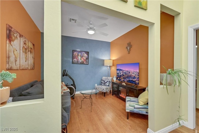 7909 Canoe Ln, Las Vegas, NV 89145 - living area with wood finished floors, a ceiling fan, and an accent wall