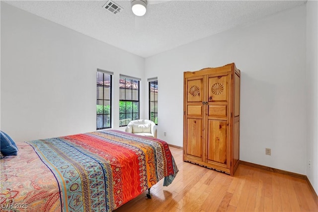 7909 Canoe Ln, Las Vegas, NV 89145 - bedroom featuring light wood-type flooring and a textured ceiling