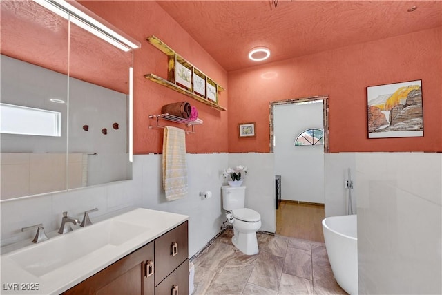 7909 Canoe Ln, Las Vegas, NV 89145 - full bath featuring vanity, a freestanding tub, marble finish flooring, and a textured ceiling
