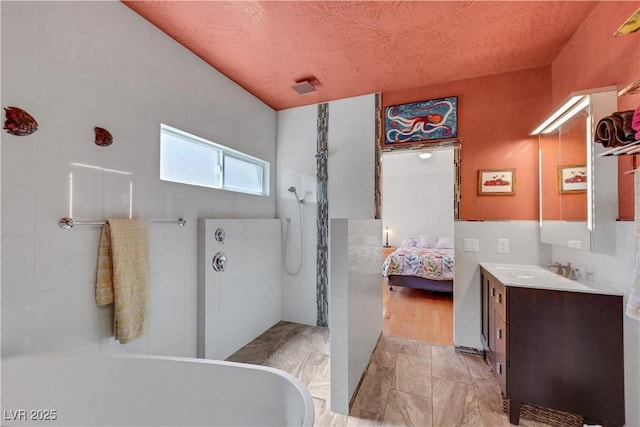 7909 Canoe Ln, Las Vegas, NV 89145 - ensuite bathroom featuring vanity, a freestanding tub, a walk in shower, and marble finish floors