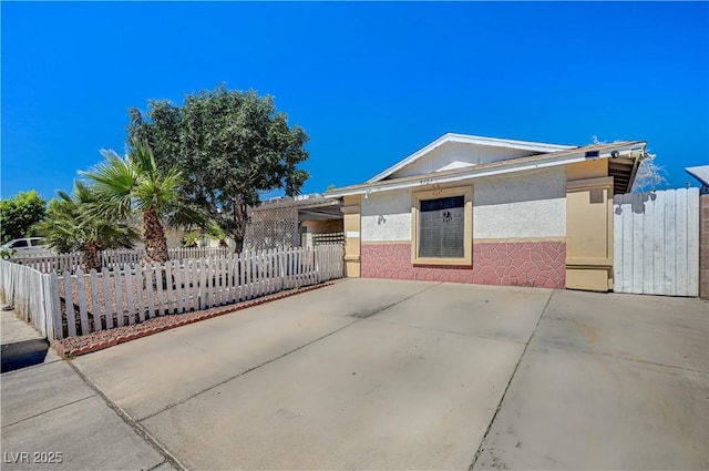 5121 Gains Mill St, Las Vegas, NV 89122 - view of front of house with a fenced front yard and stucco siding