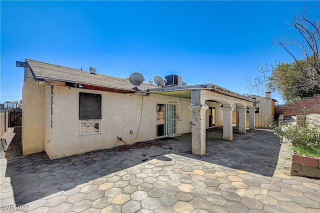 5121 Gains Mill St, Las Vegas, NV 89122 - rear view of house featuring stucco siding and a patio area