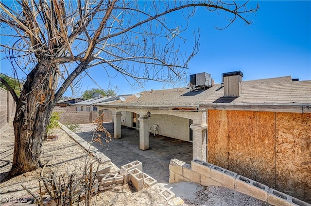 5121 Gains Mill St, Las Vegas, NV 89122 - view of side of property featuring a fenced backyard, a patio, a chimney, and roof with shingles