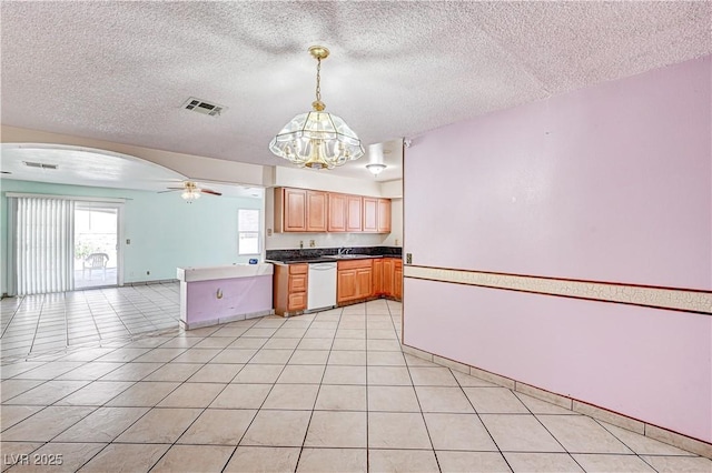 5121 Gains Mill St, Las Vegas, NV 89122 - kitchen featuring white dishwasher, open floor plan, a chandelier, a textured ceiling, and arched walkways