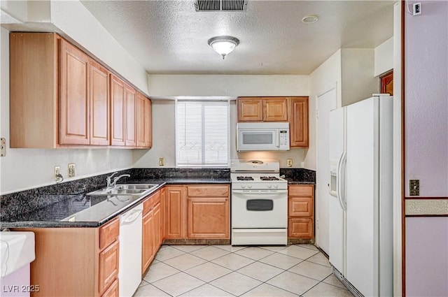 5121 Gains Mill St, Las Vegas, NV 89122 - kitchen featuring white appliances, a textured ceiling, and light tile patterned floors