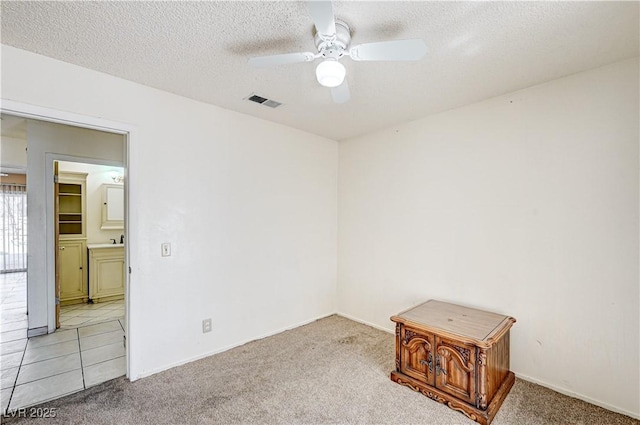5121 Gains Mill St, Las Vegas, NV 89122 - unfurnished room with a ceiling fan, light colored carpet, and a textured ceiling