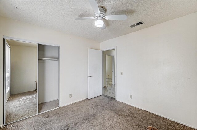 5121 Gains Mill St, Las Vegas, NV 89122 - unfurnished bedroom featuring carpet, a textured ceiling, a closet, and a ceiling fan