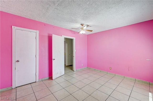 5121 Gains Mill St, Las Vegas, NV 89122 - unfurnished bedroom with a textured ceiling, a ceiling fan, and light tile patterned floors