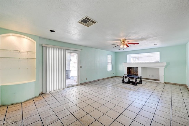 5121 Gains Mill St, Las Vegas, NV 89122 - unfurnished living room with a ceiling fan, a textured ceiling, and light tile patterned floors