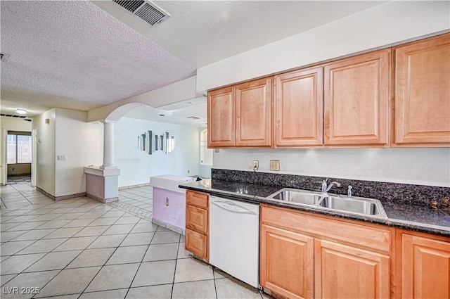 5121 Gains Mill St, Las Vegas, NV 89122 - kitchen featuring dishwasher, dark countertops, light tile patterned floors, a textured ceiling, and decorative columns
