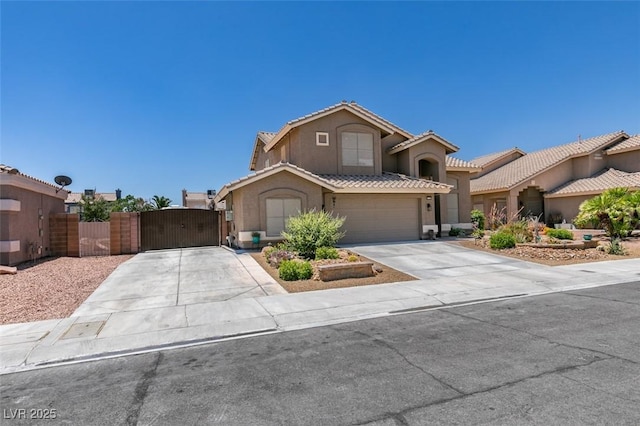 6109 Sandstone Mesa Dr, Las Vegas, NV 89130 - view of front facade with a gate, concrete driveway, stucco siding, a tiled roof, and an attached garage