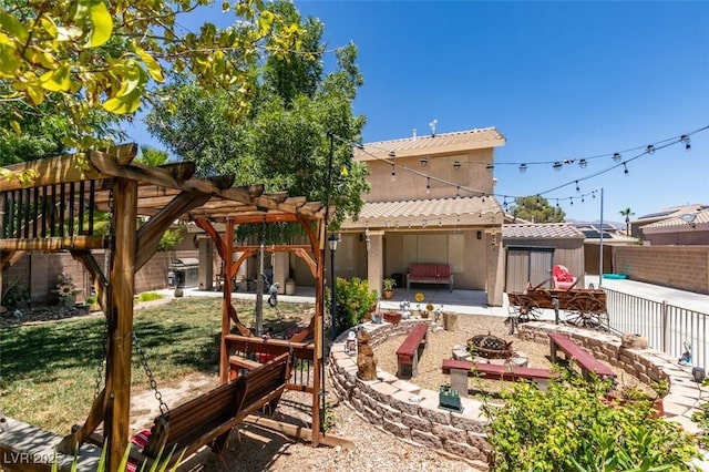 6109 Sandstone Mesa Dr, Las Vegas, NV 89130 - back of property with an outdoor fire pit, a patio area, a fenced backyard, and a pergola