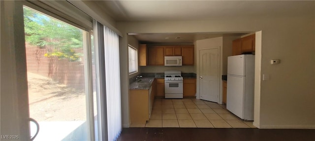 5413 Bristol Bend Ct, Las Vegas, NV 89135 - kitchen featuring white appliances, brown cabinetry, and light tile patterned flooring