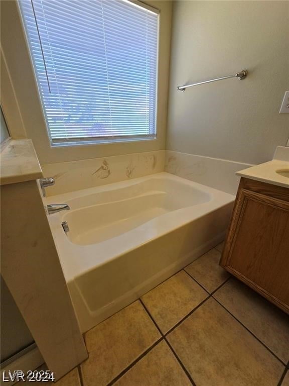 5413 Bristol Bend Ct, Las Vegas, NV 89135 - bathroom featuring a garden tub, vanity, and tile patterned flooring