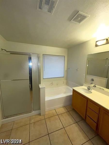 5413 Bristol Bend Ct, Las Vegas, NV 89135 - bathroom featuring tile patterned flooring, a garden tub, vanity, and a shower stall