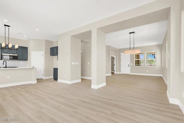 5908 Big Horn View St, North Las Vegas, NV 89031 - unfurnished living room featuring light wood finished floors and recessed lighting