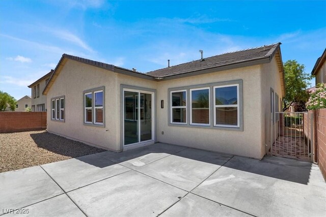 5908 Big Horn View St, North Las Vegas, NV 89031 - back of property featuring a fenced backyard, stucco siding, and a patio area