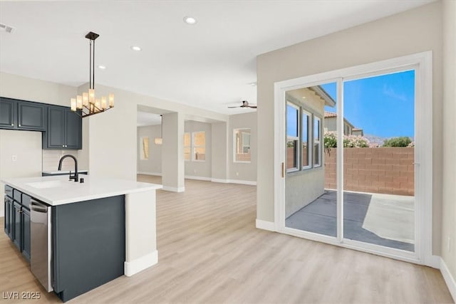 5908 Big Horn View St, North Las Vegas, NV 89031 - kitchen with light countertops, light wood-style floors, a chandelier, a ceiling fan, and decorative light fixtures