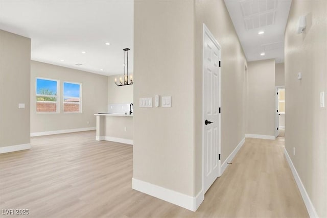 5908 Big Horn View St, North Las Vegas, NV 89031 - corridor featuring light wood finished floors, a chandelier, and recessed lighting
