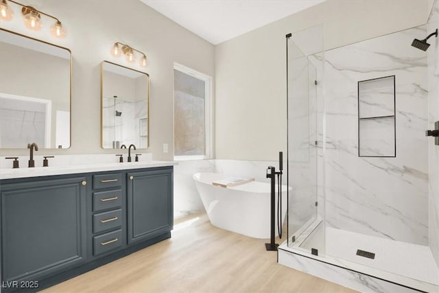 5908 Big Horn View St, North Las Vegas, NV 89031 - bathroom with a marble finish shower, a soaking tub, double vanity, and wood finished floors
