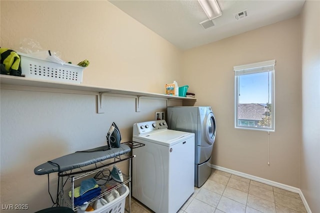 10693 Harvest Green Way, Las Vegas, NV 89135 - laundry room with washer and clothes dryer and light tile patterned flooring