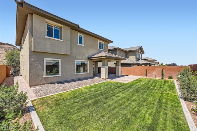 10693 Harvest Green Way, Las Vegas, NV 89135 - rear view of property with a fenced backyard, stucco siding, and a patio
