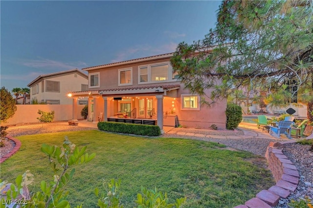 4651 Munich Ct, Las Vegas, NV 89147 - rear view of house featuring a patio area, a fenced backyard, stucco siding, and a tile roof