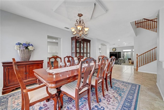 4651 Munich Ct, Las Vegas, NV 89147 - dining area featuring stairway, a chandelier, light tile patterned flooring, recessed lighting, and arched walkways