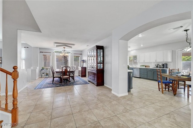 4651 Munich Ct, Las Vegas, NV 89147 - dining room with light tile patterned floors and arched walkways