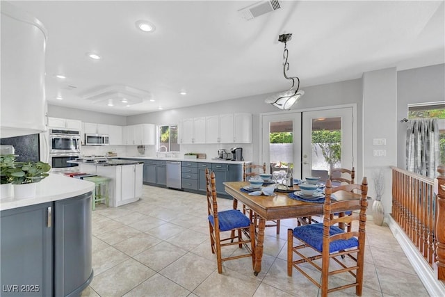 4651 Munich Ct, Las Vegas, NV 89147 - dining area with healthy amount of natural light, french doors, light tile patterned floors, and recessed lighting