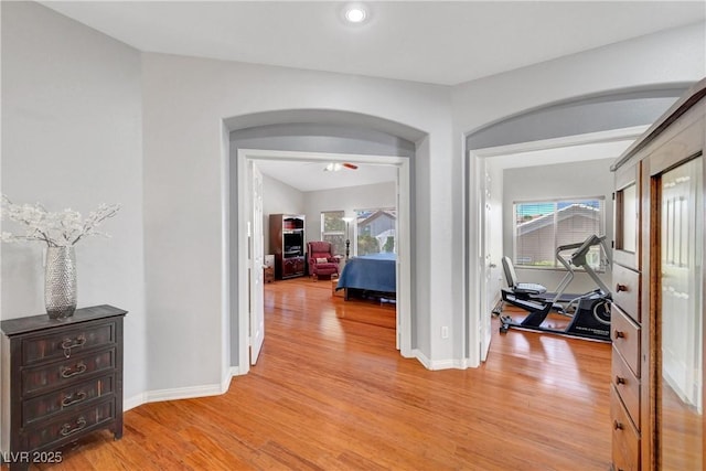 4651 Munich Ct, Las Vegas, NV 89147 - corridor with light wood finished floors, healthy amount of natural light, and arched walkways