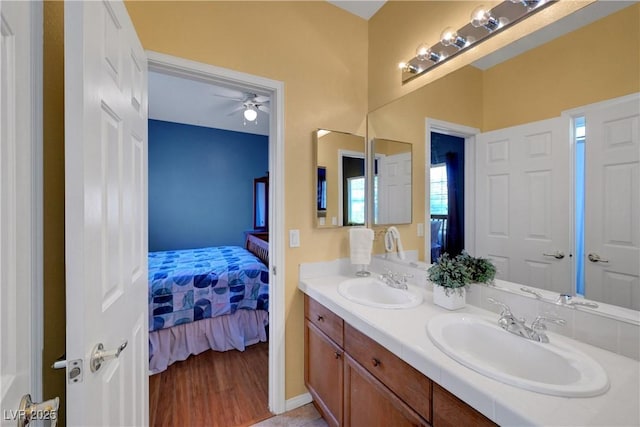 4651 Munich Ct, Las Vegas, NV 89147 - bathroom featuring double vanity, ensuite bath, and ceiling fan