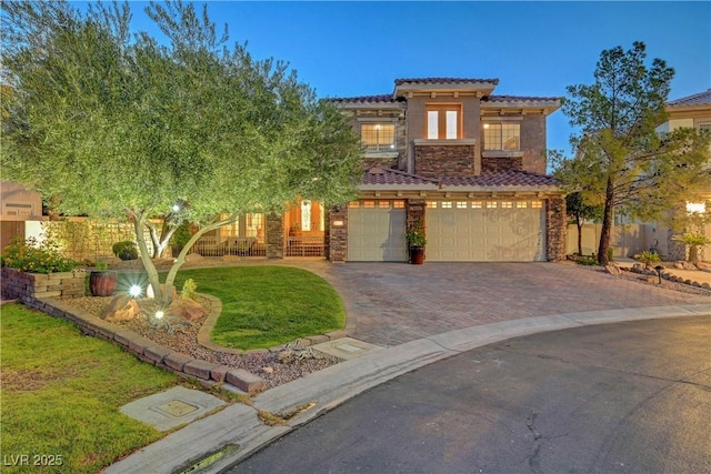 4651 Munich Ct, Las Vegas, NV 89147 - view of front facade with stone siding, a garage, driveway, a tile roof, and stucco siding
