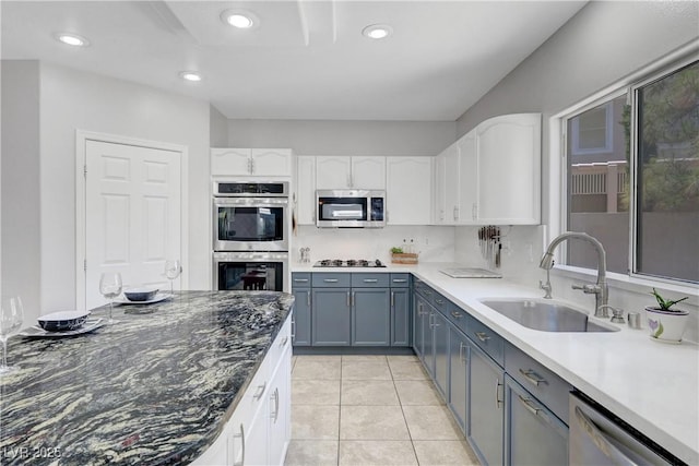 4651 Munich Ct, Las Vegas, NV 89147 - kitchen featuring appliances with stainless steel finishes, white cabinets, light tile patterned floors, recessed lighting, and gray cabinets
